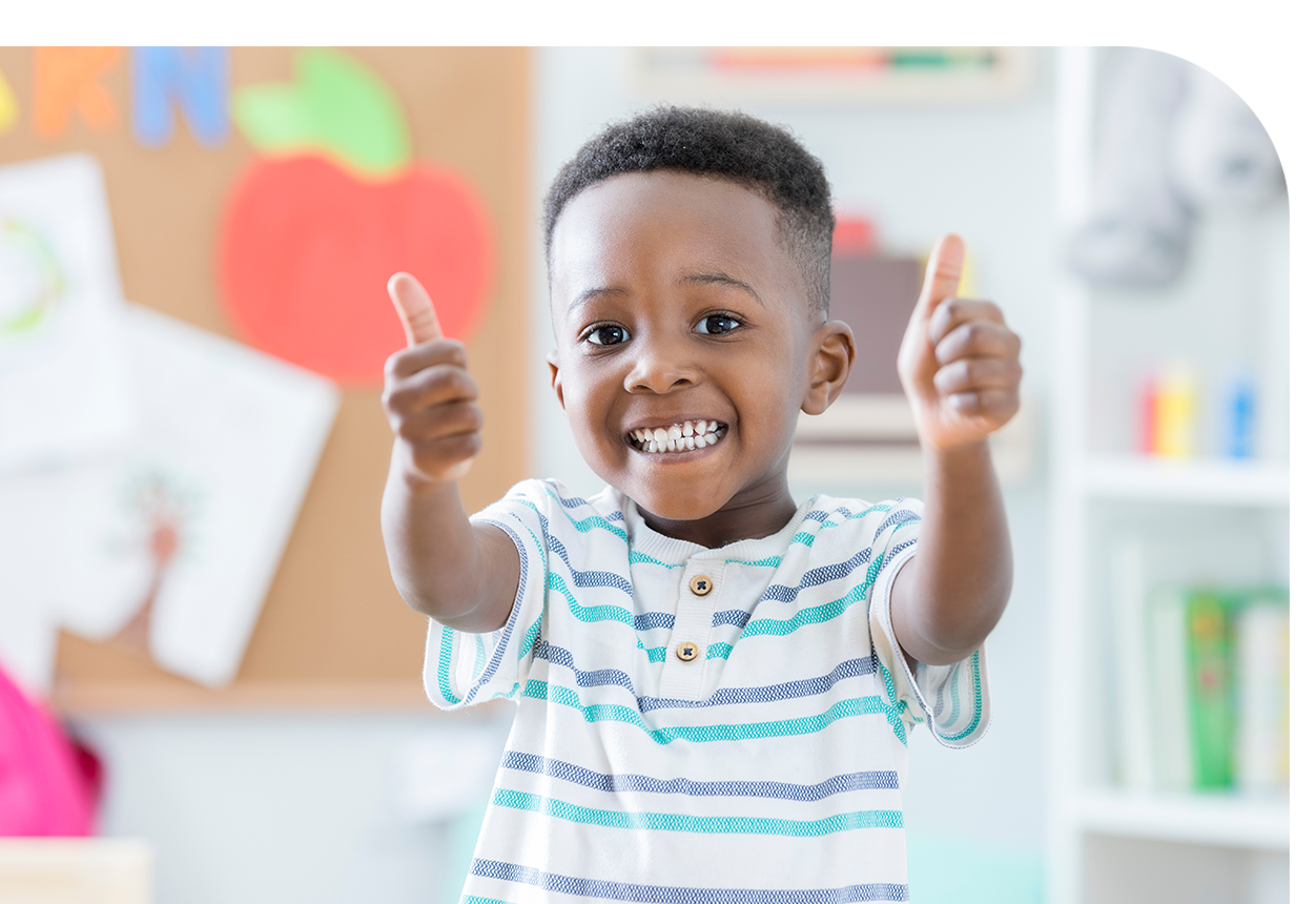 A young boy giving a thumbs up